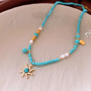 Bohemian turquoise beaded necklace with golden sun pendant and pearl accents