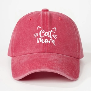 Close-up of embroidered Cat Mom text and cat ears on a washed red cotton baseball cap