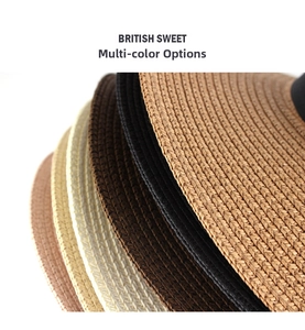 Detailed stack of woven straw Panama hats in various colors with fine texture