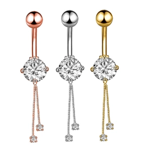 Detailed view of rose gold, silver, and gold belly rings with crystal zircon tassels