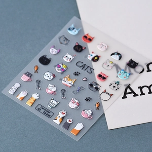 Detail of 5D embossed nail stickers featuring cute 3D cats, paws, and fish bone designs