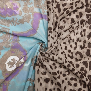 Detail of soft chiffon fabric featuring mixed baroque and leopard print patterns