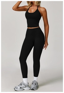 Detail shot of black halter yoga set featuring high-waist leggings and racerback sports top
