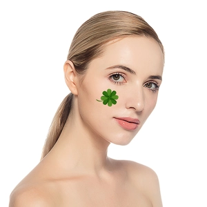 Waterproof St. Patrick's Day shamrock face tattoos on professional makeup model
