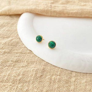 Macro shot of 18K gold plated brass stud earrings with round green malachite stones