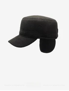 Detailed side view of dark grey winter flat cap with ear flaps and metal sports logo