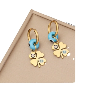 Gold evil eye hoop earrings with four-leaf clover flower pendants and blue beads