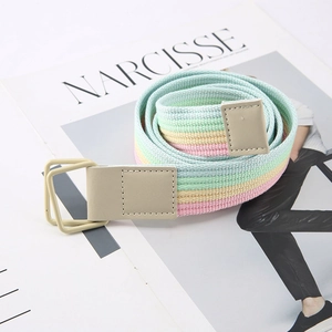 Rainbow striped woven canvas belt with square buckle on a fashion magazine background