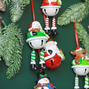 Christmas bell ornaments featuring Santa, snowman, and reindeer on snowy pine branches