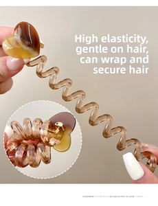 Detail of high-elasticity amber heart spiral hair tie showing its stretchable texture