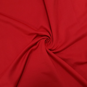 Detailed macro view of dark red fabric showing fine knitted texture and soft drapes