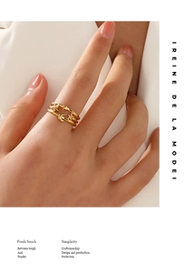 Detail of gold-plated three-layer ring featuring celestial star and moon patterns