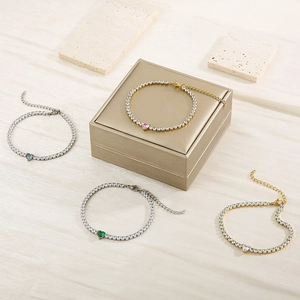 Detailed shot of gold and silver tennis bracelets with colorful heart-shaped zircons