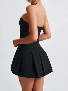 Detail view of black strapless mini dress back featuring pleated skirt and zipper closure