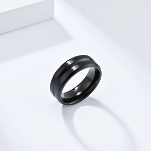 Macro view of black brushed stainless steel ring with center groove detail