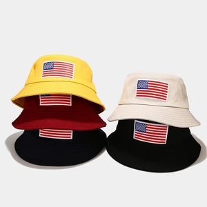 Detail of USA flag embroidered bucket hats in multiple colors including yellow and beige