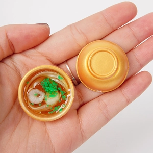Miniature golden bowl noodle keychain with detailed shrimp and scallion garnishes