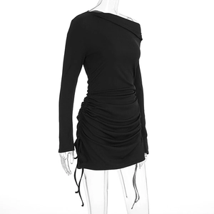 Close-up of black ribbed long sleeve mini dress featuring side ruched drawstring details