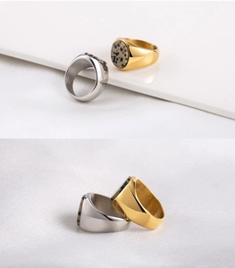 Macro detail of 18K gold and silver plated steel rings with spotted stone inlays