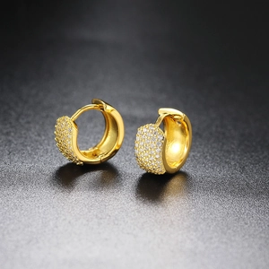 Close-up of gold-plated huggie earrings featuring five rows of pave-set cubic zirconia