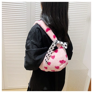 Plush heart pattern handbag detail showing the soft faux fur texture and polka dot scarf