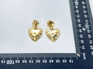 Detail of gold heart earrings with hammered texture and diamond studs showing 30mm height