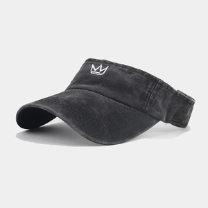 Close-up of black washed cotton sun visor hat with white embroidered crown logo details