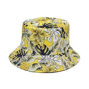 Detail of yellow bucket hat with tropical leaf floral print on cotton canvas fabric