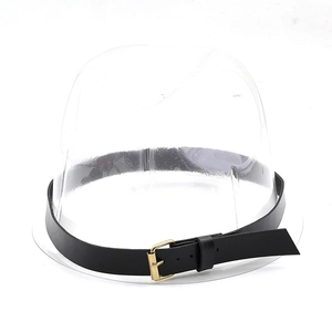 Detail of a black faux leather hat band with a golden metal buckle on a clear display