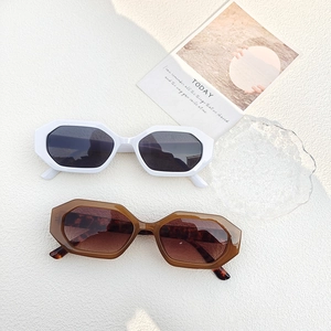 Stylish hexagonal sunglasses in white and tortoiseshell frames with gradient lenses