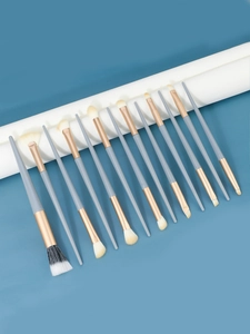 Detail view of 13-piece makeup brush set with rose gold ferrules and soft grey handles