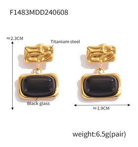 Detail showing vintage gold titanium steel earrings with black glass inlay and dimensions