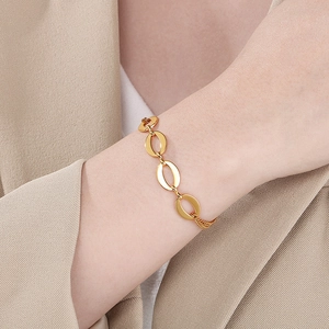Elegant gold oval link chain bracelet shown on a model wrist for a minimalist luxury look