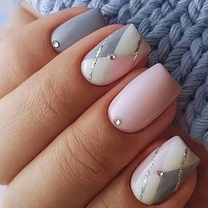 Gray and pink geometric press-on nails with silver glitter lines and rhinestones