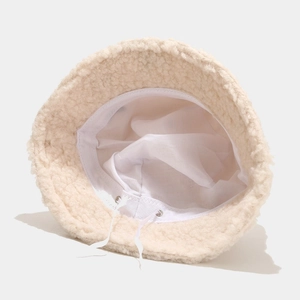 Detail of beige teddy fleece bucket hat showing inner lining and adjustable drawstring