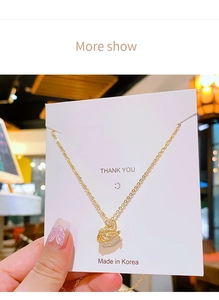Detailed view of a gold swan pendant necklace featuring brilliant cubic zirconia stones