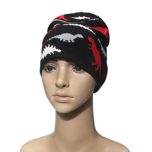 Winter knit beanie featuring colorful dinosaur jacquard patterns on black yarn