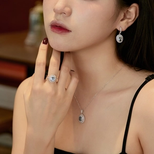 Close-up of elegant S925 silver set with light blue oval gemstones and halo crystals