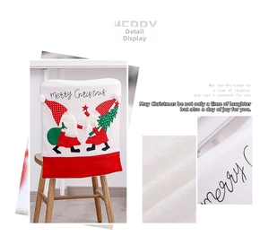 Detail of white plush Christmas chair cover with gnome embroidery and Merry Christmas text