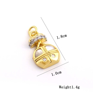 Detailed size view of gold-tone bag pendant with white inlay and zirconia stones