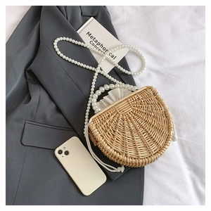 Detail of handmade woven bamboo bag with luxury pearl handle and drawstring lining