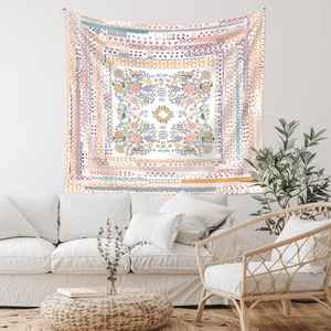 Detail of bohemian mandala tapestry with colorful floral patterns on a living room wall