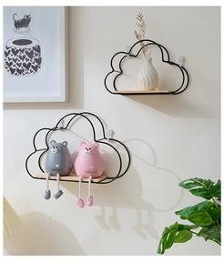 Close-up of Nordic cloud-shaped iron wall shelf with wooden base and decor