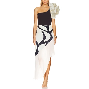 Detail of elegant one-shoulder swimsuit with large white 3D ruffle flower and black bodice