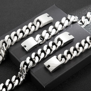 Macro detail of silver stainless steel Cuban link chains with textured brush finish