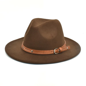 Detail of dark brown wool fedora hat with a leather strap featuring metal rivets