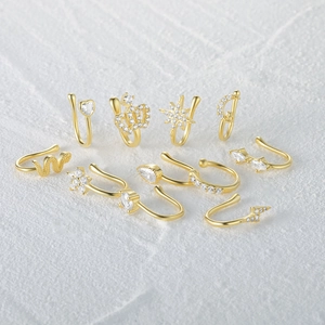 Detailed set of 10 golden S925 silver nose cuffs with crystal heart and star designs