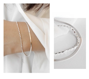 Detailed macro view of S925 sterling silver double-layer bracelet with snake and bead chains