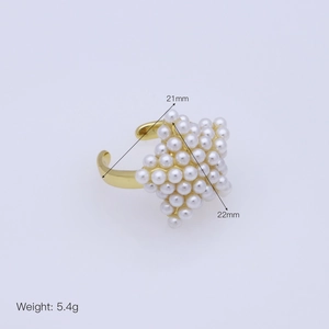 Detail view of gold open ring featuring a pearl star design with 5.4g weight and size labels