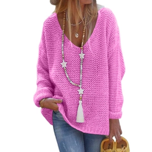 Detail of hot pink V-neck knit sweater with long sleeves and elegant tassel necklace